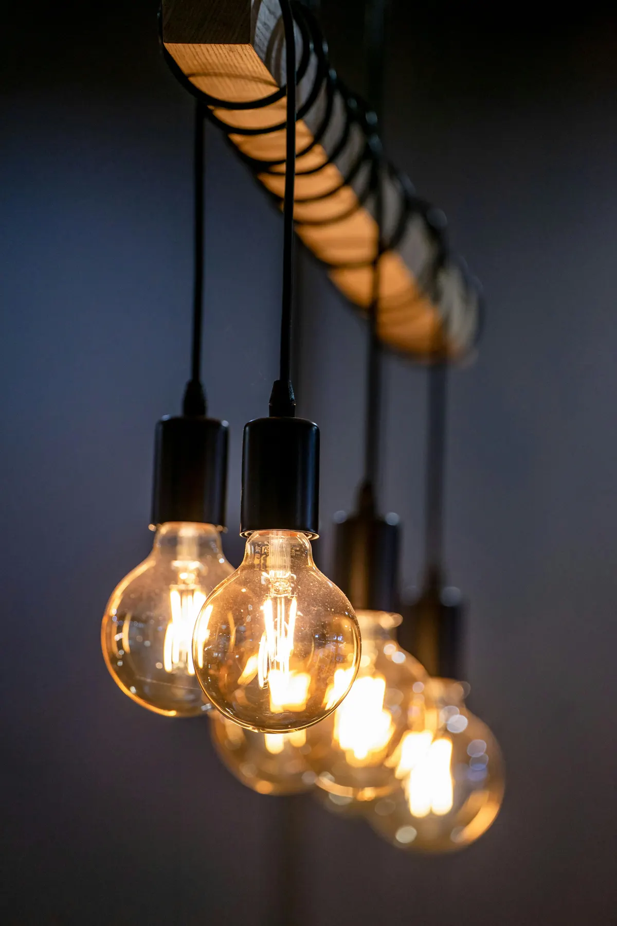 Row of pendant light fixtures with exposed bulbs